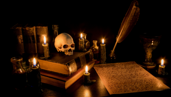 books, parchment, pen, ink, skull